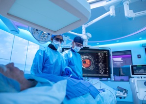 Physicians performing an image-guided procedure with live IVUS imaging on a Philips interventional lab monitor
